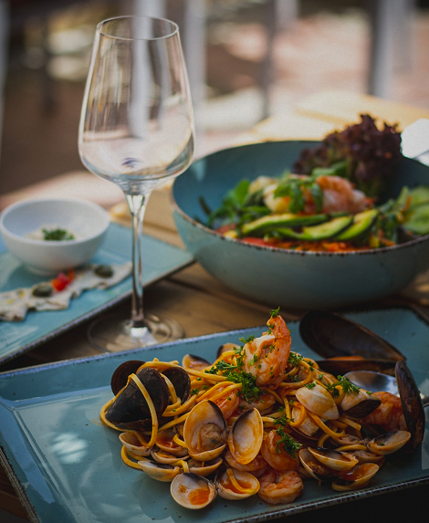 Elegant plated wedding cuisine with glassware and salad